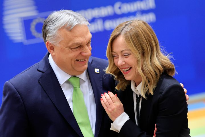 Italian Prime Minister Giorgia Meloni (right) shares a light moment with Hungarian Prime Minister Viktor Orbán in March. Meloni's critics say she is more like Orbán than she lets on.