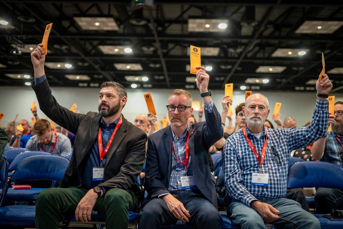 Messengers are seen raising their ballots in support of a motion put up for vote at the Indianapolis conference this week.