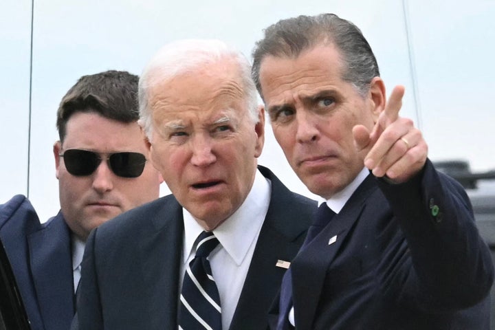 President Joe Biden talks with his son Hunter upon arrival at Delaware Air National Guard Base in New Castle, Delaware, on Tuesday. A jury found Hunter Biden guilty earlier that day on federal gun charges.