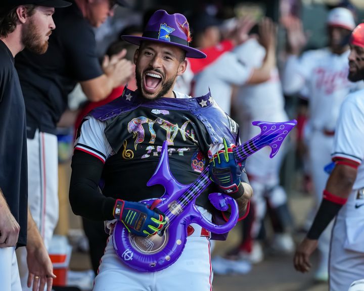 MINNEAPOLIS, MN - JUNE 13: Carlos Correa #4 of the Minnesota Twins celebrates in a Prince vest and guitar after hitting a home run against the Oakland Athletics on June 13, 2024 at Target Field in Minneapolis, Minnesota. (Photo by Brace Hemmelgarn/Minnesota Twins/Getty Images)