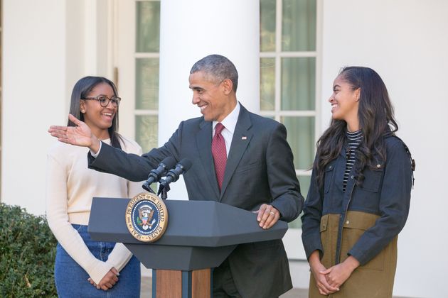 First daughters Sasha and Malia join their dad, President Barack Obama, in the Rose Garden at the White House on November 25, 2015.