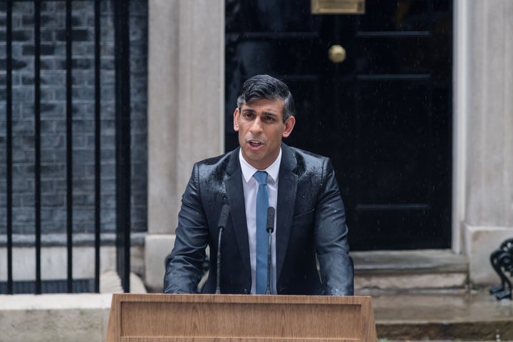 Sunak stands in the rain outside 10 Downing St. in London on May 22, 2024, as he announces the date of the next U.K. general election.