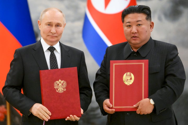 North Korea Rolls Out The Crimson Carpet For Putin As Nations Signal 'Strongest Ever Treaty' 1 Russian President Vladimir Putin, left, and North Korea's leader Kim Jong Un pose for a photo during a signing ceremony of the new partnership in Pyongyang, North Korea, on June 19, 2024.