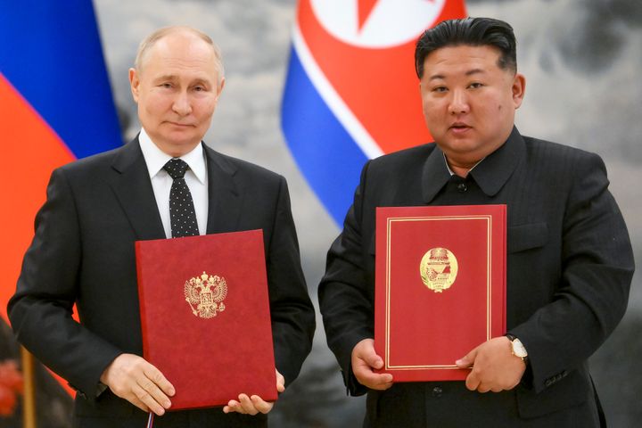 Russian President Vladimir Putin, left, and North Korea's leader Kim Jong Un pose for a photo during a signing ceremony of the new partnership in Pyongyang, North Korea, on June 19, 2024. 