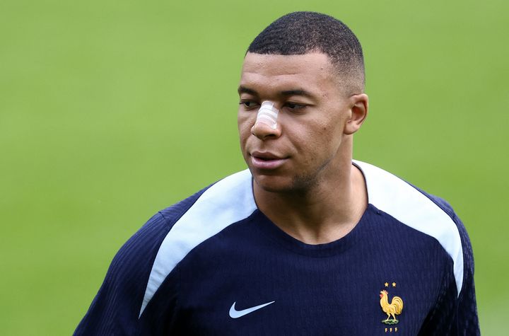 Ο επιθετικός της Γαλλίας Kylian Mbappe, φορώντας ένα τσιρότο μετά το σπάσιμο της μύτης του κατά τη διάρκεια της εναρκτήριας νίκης της χώρας του εναντίον της Αυστρίας, παρακολουθεί μια προπόνηση κατά τη διάρκεια του UEFA Euro 2024, στο στάδιο Home Deluxe Arena στο Paderborn της δυτικής Γερμανίας, στις 19 Ιουνίου 2024. Ο Mbappe υποβλήθηκε σε εξετάσεις σε νοσοκομείο του Ντίσελντορφ πριν επανενταχθεί στην ομάδα της Γαλλίας στη βάση της στο Paderborn. (Photo by FRANCK FIFE / AFP) (Photo by FRANCK FIFE/AFP via Getty Images)