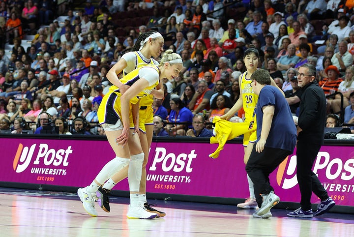 Los Angeles Sparks forward Cameron Brink (22) sustains an injury and assisted off the court by Los Angeles Sparks forward Dearica Hamby (5) during a WNBA game between Los Angeles Sparks and Connecticut Sun on June 18, 2024, at Mohegan Sun Arena in Uncasville, CT.