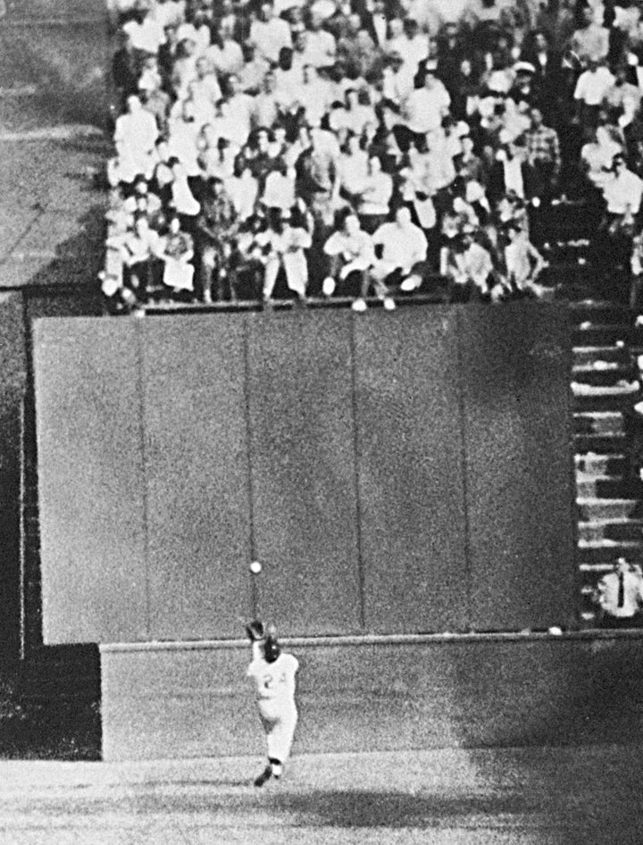 FILE - New York Giants center fielder Willie Mays, with his back to the plate, gets under a 450-foot blast off the bat of Cleveland Indians first baseman Vic Wertz to pull the ball down in front of the bleachers wall in the eighth inning of Game 1 of the World Series at the Polo Grounds in New York, Sept. 29, 1954. Willie Mays, the electrifying “Say Hey Kid” whose singular combination of talent, drive and exuberance made him one of baseball’s greatest and most beloved players, has died. He was 93. Mays' family and the San Francisco Giants jointly announced Tuesday night, June 18, 2024, he had died earlier in the afternoon in the Bay Area.(AP Photo/File)