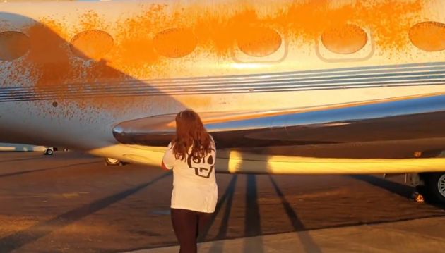 A private plane is sprayed with orange paint during a Just Stop Oil demonstration