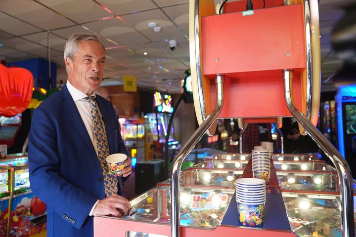 Reform UK leader Nigel Farage playing a 2p machine in Clacton-on-Sea, where he is standing for parliament.