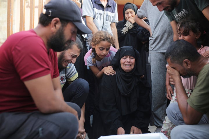 A Palestinian family mourns a loved one killed by Israeli bombardment , as they take a last look before their funeral in Khan Younis, southern Gaza Strip, Friday, June 21, 2024. (AP Photo /Jehad Alshrafi)