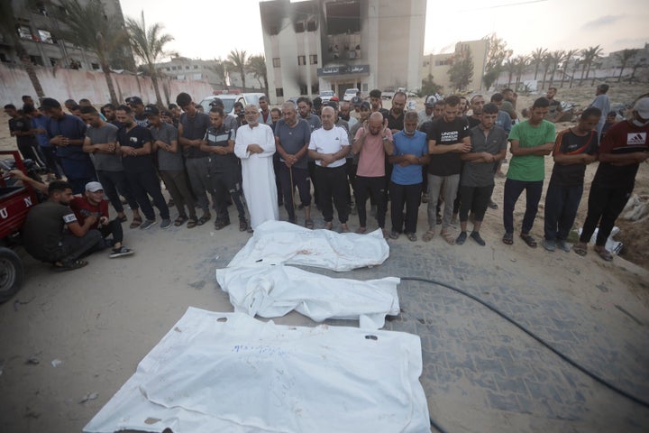 Palestinians pray for victims of Israeli bombardment before their burial in Khan Younis, southern Gaza Strip, Friday, June 21, 2024. (AP Photo /Jehad Alshrafi)