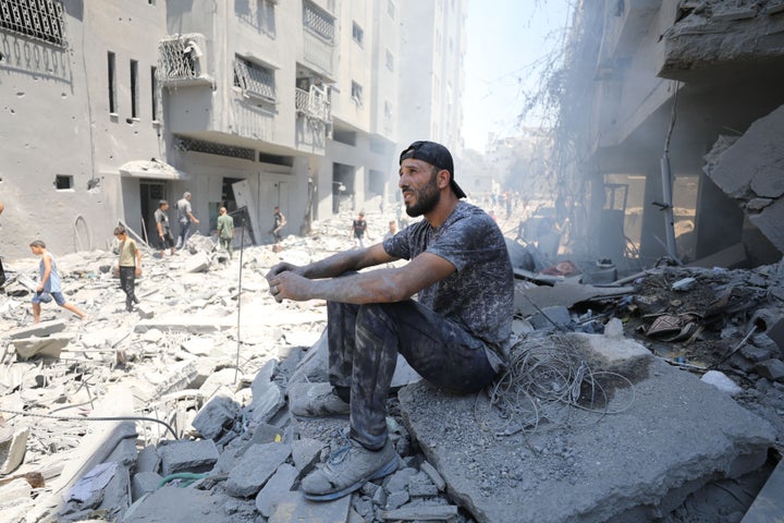GAZA CITY, GAZA - JUNE 22: A Palestinian man sits on rubbles of destroyed buildings following the Israeli attacks on Al-Shati refugee camp in Gaza City, Gaza on June 22, 2024. It was reported that there were dead and wounded in the attacks, including children. (Photo by Dawoud Abo Alkas/Anadolu via Getty Images)