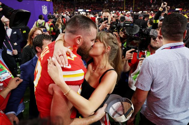 Travis Kelce and Taylor Swift share a kiss after his win at the 2024 Super Bowl