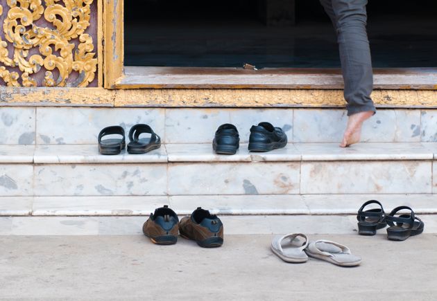 Shoes left at the steps of a Buddhist temple in Laos. Many religious locations around the world require that shoes be removed before entering.
