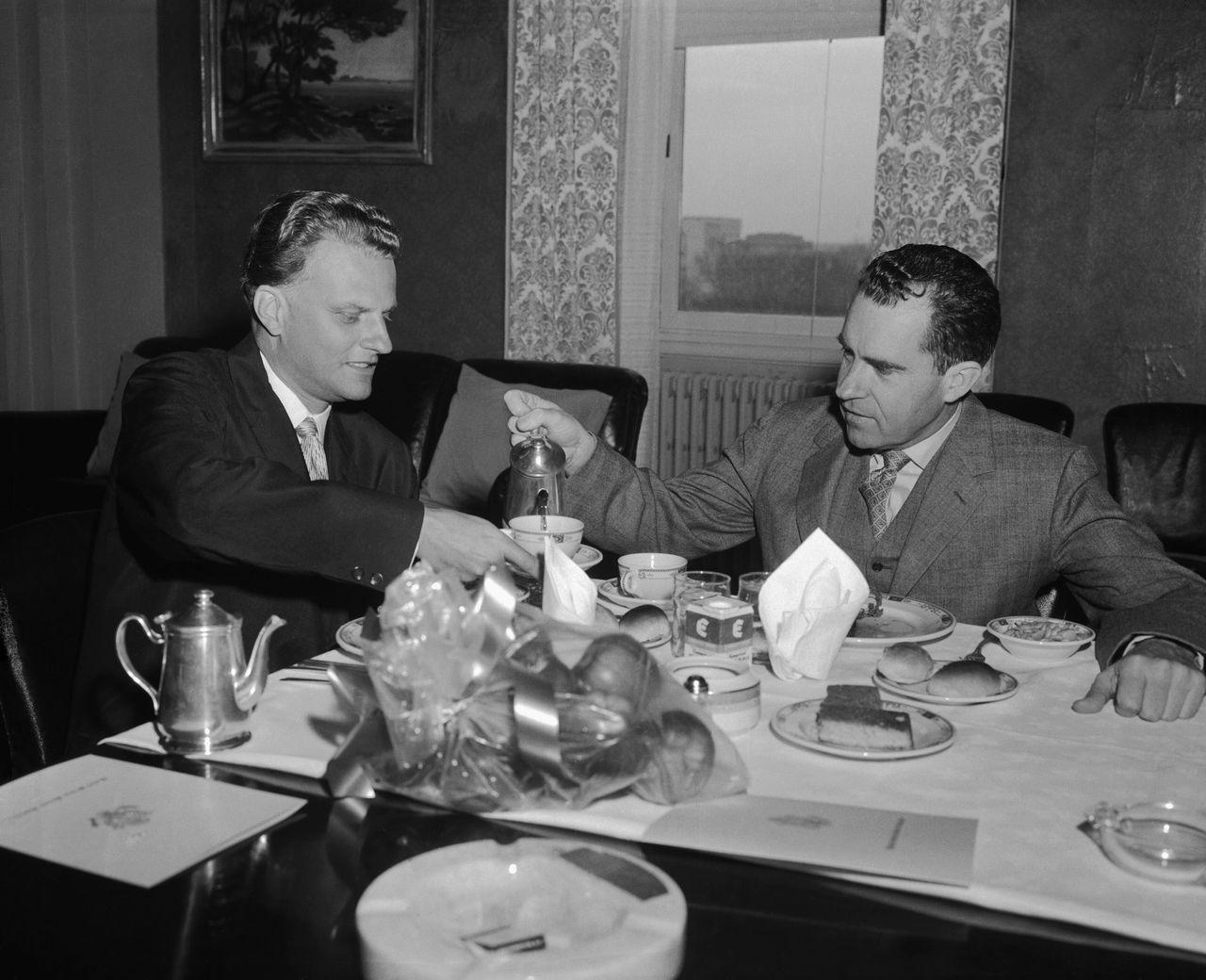 Richard Nixon, vice president at the time of this photo, pours coffee for the Reverend Billy Graham during a private luncheon in his office. Later, when Nixon became president, recordings in the Oval Office captured Graham, an ardent Christian Zionist, making antisemitic remarks.