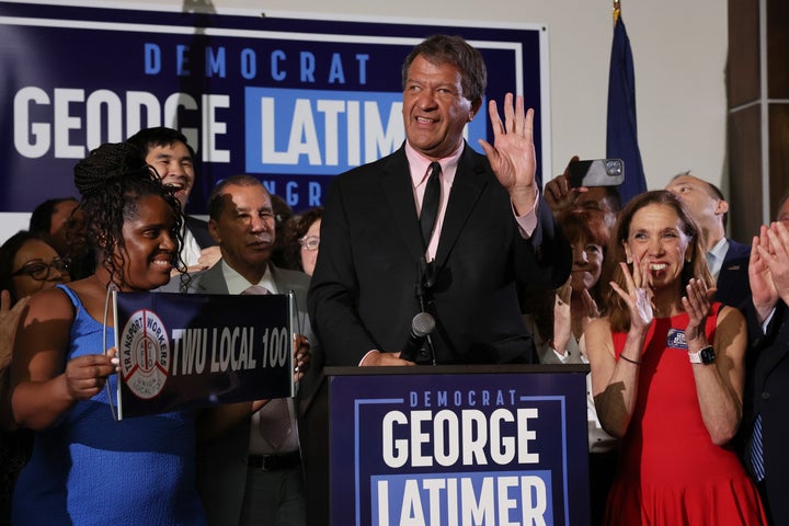 Latimer celebrates with supporters after winning on Tuesday.