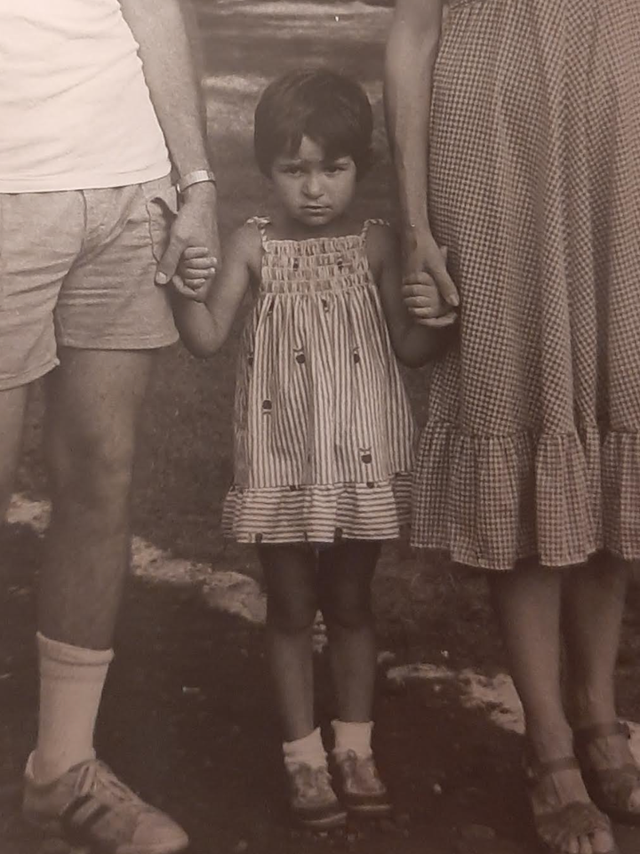 "This is me, age 2, holding my parents’ hands," the author writes. "I wasn’t the most cheerful child."