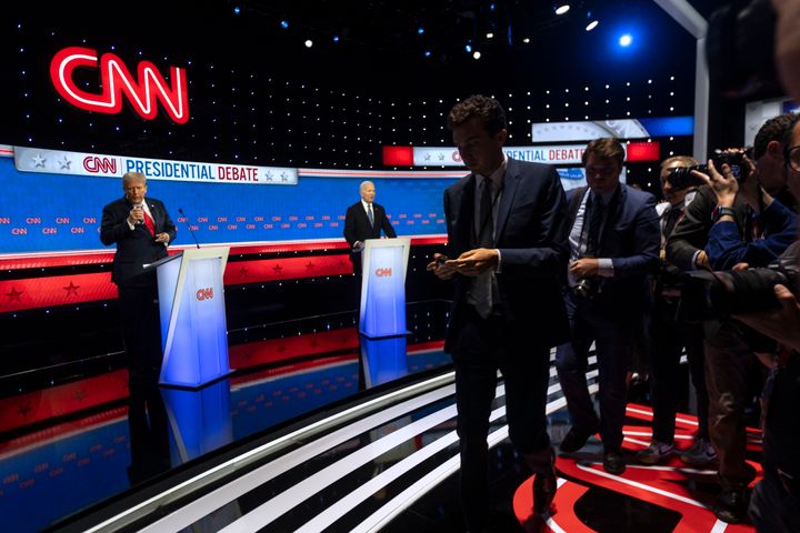 Former President and Republican presidential candidate Donald Trump takes a drink of water next to President Joe Biden as the press exits the debate stage during the first presidential debate of the 2024 elections at CNN's studios in Atlanta, Georgia, on June 27, 2024. (Photo by CHRISTIAN MONTERROSA/AFP via Getty Images)