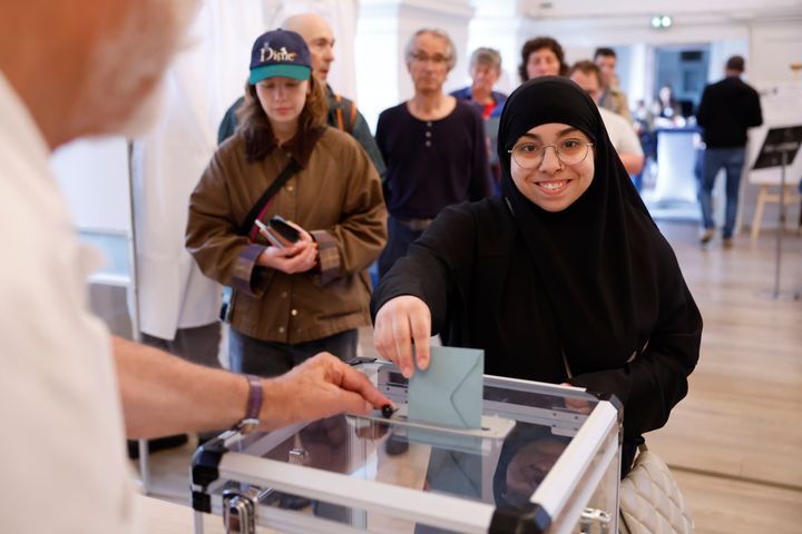 A woman votes in Strasbourg, eastern France, Sunday, June 30, 2024. (AP Photo/Jean-Francois Badias)