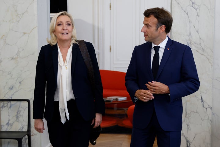 FILE - French President Emmanuel Macron, right, meets French far-right Rassemblement National (National Rally) leader Marine Le Pen at the Elysee Palace on June 21, 2022 in Paris. The perspective of a defeat in parliamentary elections mean he may have to share power with a prime minister from rival political party — that could possibly be far-right National Rally's president Jordan Bardella. Macron defeated twice the National Rally's leader Marine Le Pen in the presidential election, both in 2017 and 2022. (Ludovic Marin/Pool photo via AP, File)