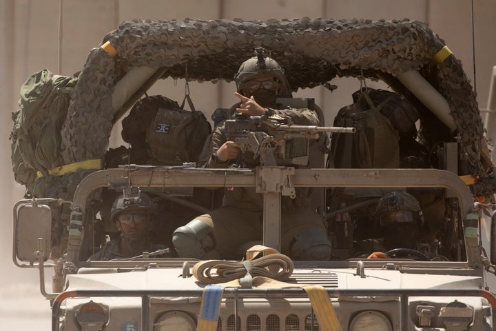 An Israeli soldier sits in a military vehicle moving along the Gaza border on June 28, 2024 in Israel.