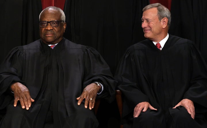 Supreme Court Chief Justice John Roberts (right) and Justice Clarence Thomas both concurred in the court's opinion that Donald Trump enjoys complete immunity for "official acts" he took as president.