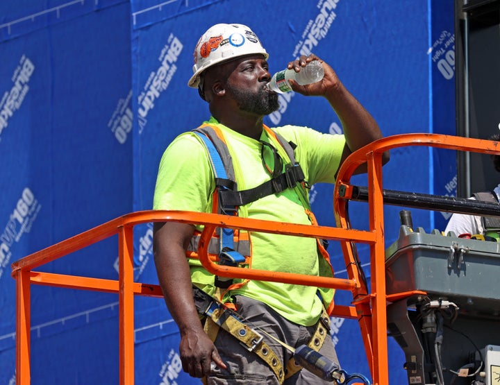 A construction worker stops for a water break while working at a site in Boston last month. An average of 33 heat-related workplace deaths and 3,389 injuries and illnesses occurred each year from 1992 to 2020.