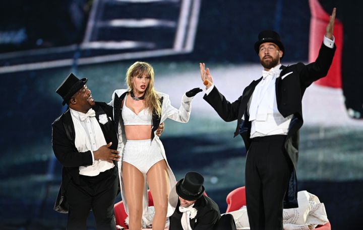 Singer Taylor Swift, center, is joined onstage by boyfriend Travis Kelce, right, during an Eras Tour stop at Wembley Stadium on June 23, 2024, in London, England.