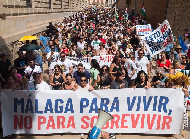 Protesters in Malaga in June 2024 with a banner that when translated into English reads, 