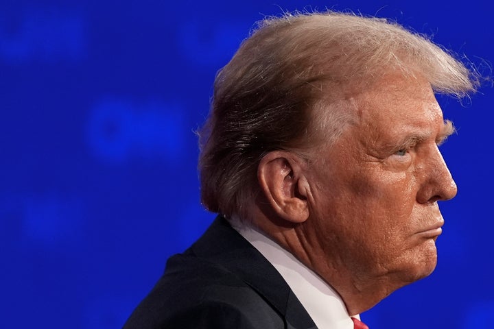 Republican presidential candidate former President Donald Trump listens to questions during a presidential debate with President Joe Biden.