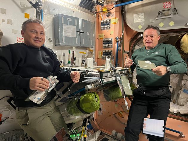 Ax-3 crew members Alper Gezeravcı and Michael López-Alegría sharing a meal aboard the ISS in 2023.