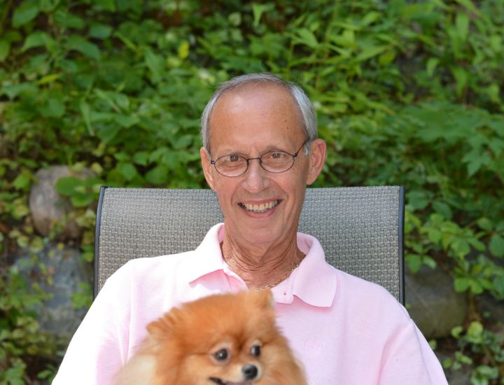 The author's dad sits with her dog, Sophie.