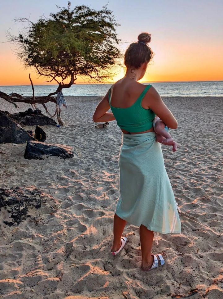 "This photo is of me and my daughter when she was about 5 months old," the author writes. "We had finally overcome breastfeeding challenges, and now I was able to feed her just about anywhere — even on the beach!"