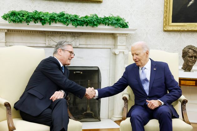 Joe Biden and Keir Starmer shake hands while speaking to reporters before participating in a bilateral meeting in the Oval Office of the White House.