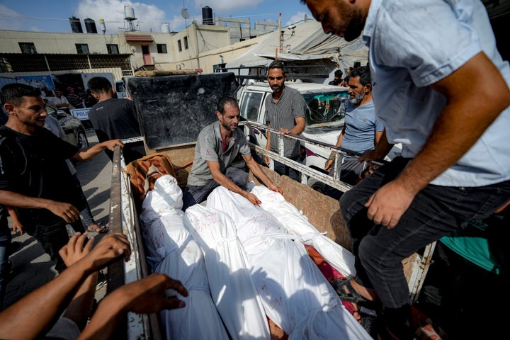 Palestinians gather near the bodies of their relatives killed in the Israeli bombardment of the Gaza Strip, at a hospital morgue in Deir al-Balah, Saturday, July 13, 2024. (AP Photo/Abdel Kareem Hana)