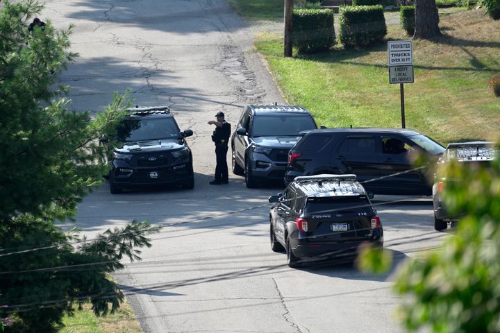 Law enforcement officers block a street in Bethel Park, Pennsylvania, that they say had a residence of Thomas Matthew Crooks, the suspected shooter in the attack on former President Donald Trump.