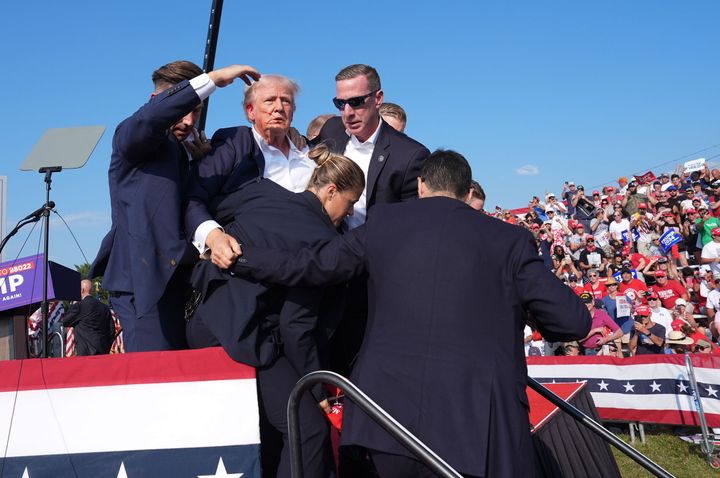 Trump is assisted offstage during a campaign rally in Butler, Pennsylvania, on Saturday, July 13. A former Secret Service agent said that the shooting's handling by Trump's security team was "a failure — plain and simple."