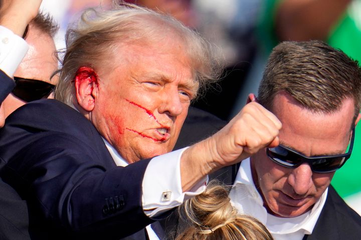 Republican presidential candidate former President Donald Trump reacts following an assassination attempt at a campaign event in Butler, Pa., on Saturday, July 13, 2024. (AP Photo/Gene J. Puskar)