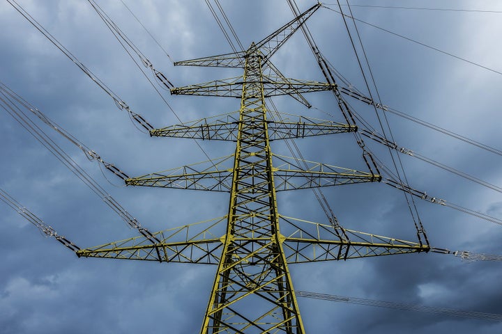 Tall large electricity pylon with dramatic sky