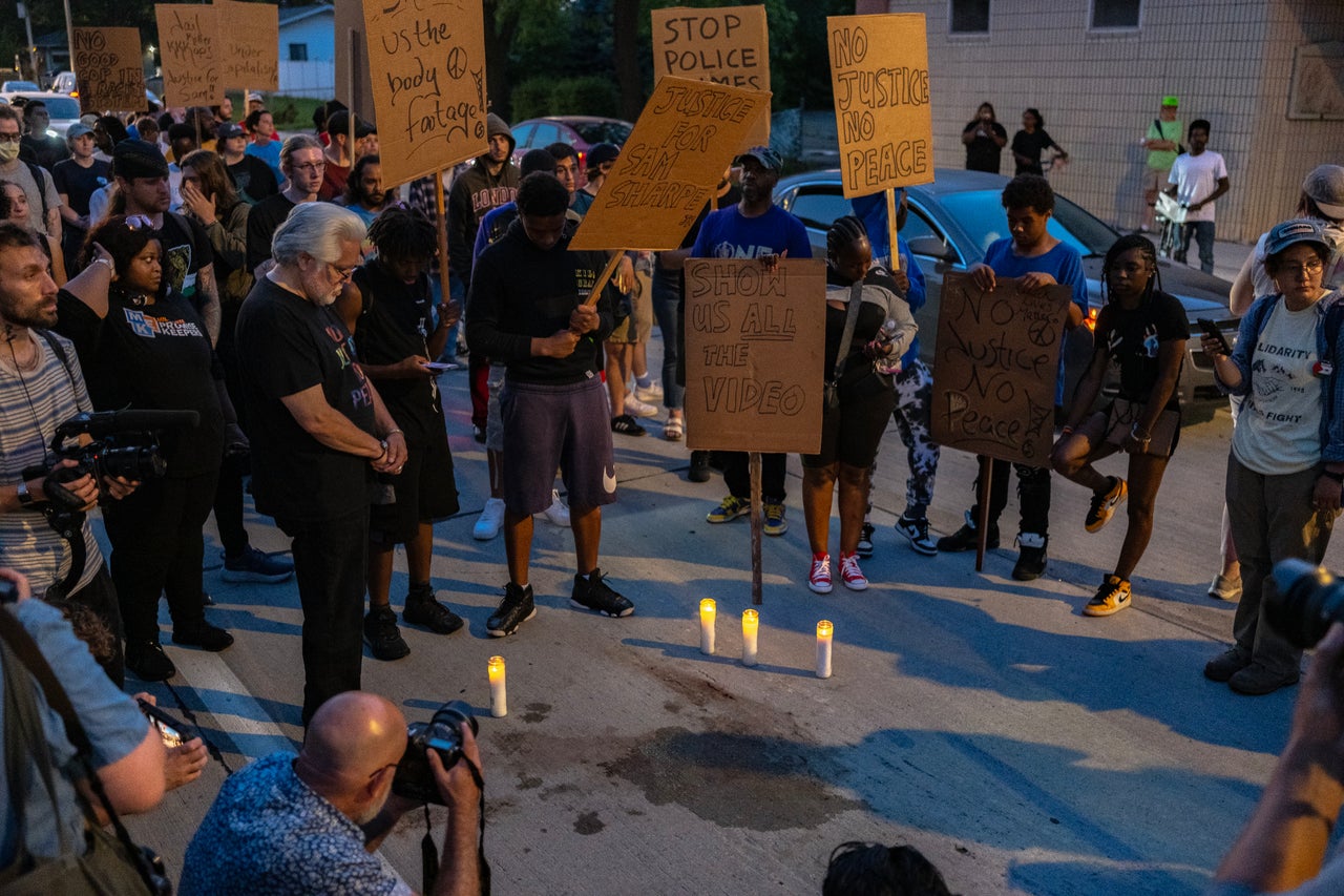 A Somber Scene Performed Out Simply 1 Mile Away From The RNC On 'Again The Blue' Evening 1 Mourners gather at the site near King Park where a man, identified by family and friends as Samuel Sharpe, was shot and killed by police about a mile from Fiserv Forum, on July 16.