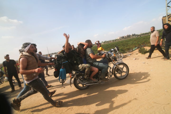 Palestinians transport a captured Israeli civilian, Noa Argamani, on a motorcycle from southern Israel into the Gaza Strip on Oct. 7, 2023. Human Rights Watch released a report Wednesday, July 17, 2024, saying Hamas-led armed groups committed numerous war crimes during the Oct. 7 attack that precipitated the ongoing offensive in Gaza.