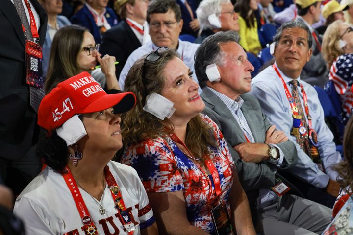 People wear fake bandages on their ears as they attend the Republican National Convention on Wednesday, July 17, 2024, in Milwaukee, Wisconsin.