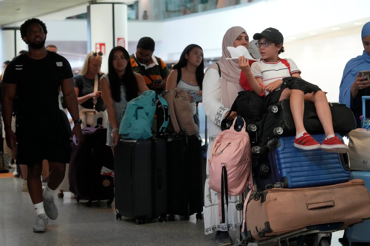 Passengers crowd the International flights departure terminal of Rome's Fiumicino airport, Friday, July 19, 2024, as many flights have been delayed or cancelled due to the worldwide internet outage. Microsoft says users worldwide may be unable to access various Microsoft 365 apps and services in a widespread outage. The cause, exact nature and scale of the outage was unclear. Microsoft appeared to suggest in its X posts that the situation was improving, but hours later, widespread outages were being reported by airlines around the world. (AP Photo/Gregorio Borgia)