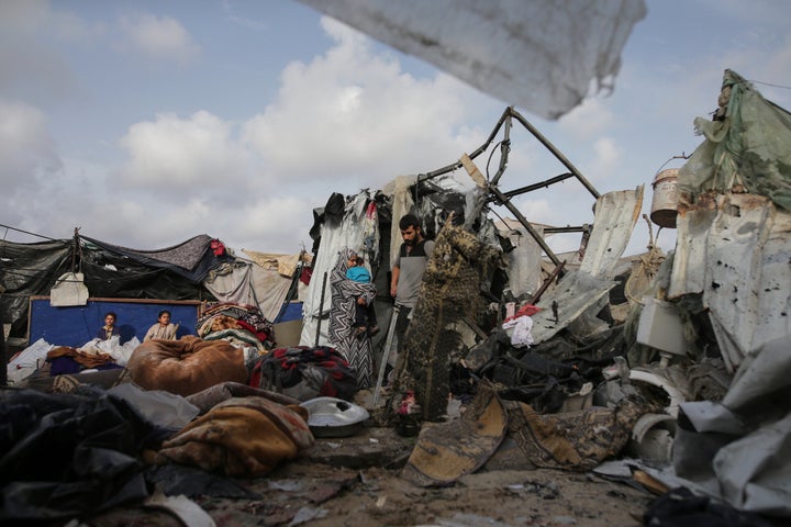 Displaced Palestinians inspect their tents destroyed by Israel's bombardment, adjunct to an UNRWA facility west of Rafah city, Gaza Strip, Tuesday, May 28, 2024.