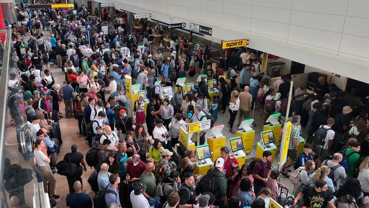 Crowds of stranded travelers wait at BWI Marshall Airport early Friday, July 19, 2024, after a worldwide technology outage impacted airlines, banks and other businesses. (Jerry Jackson/The Baltimore Sun/Tribune News Service via Getty Images)