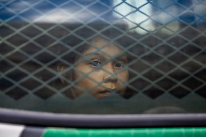 A migrant child sits in the back of a border patrol vehicle after being apprehended by U.S. Customs and Border protection officers on June 24 in Ruby, Arizona. At this week's Republican National Convention, the southern border was a common topic of concern for speakers. 