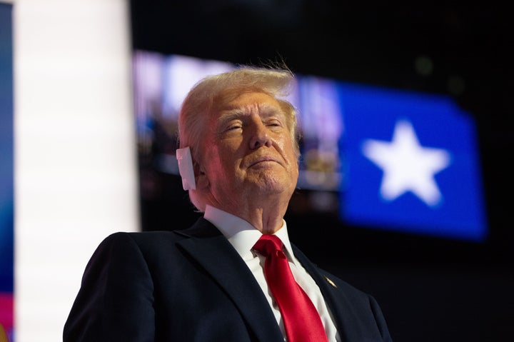 Following an attempt on his life, Donald Trump is pictured at the Republican National Convention with a bandage over his ear.