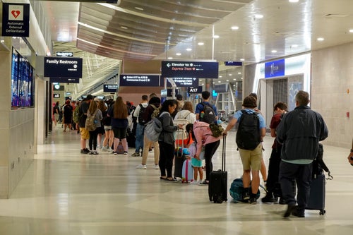 DETROIT, MICHIGAN - JULY 20: Travelers wait in a long line to speak with a Delta representative at the help desk in the McNamara terminal at the Detroit Metropolitan Wayne County Airport on July 20, 2024, in Detroit, Michigan. Many travelers were rerouted or had their flights canceled as the world continues to be affected by a global technology outage attributed to a software update administered by CrowdStrike, a cybersecurity firm whose software is used by various industries worldwide. (Photo by Joe Raedle/Getty Images)