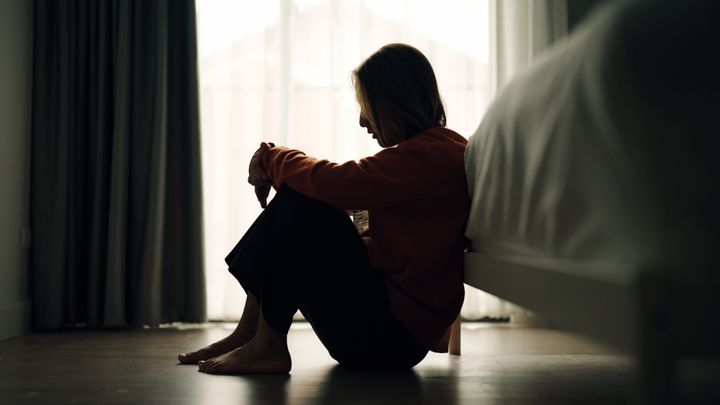 In silhouette of woman sad depression in bedroom.