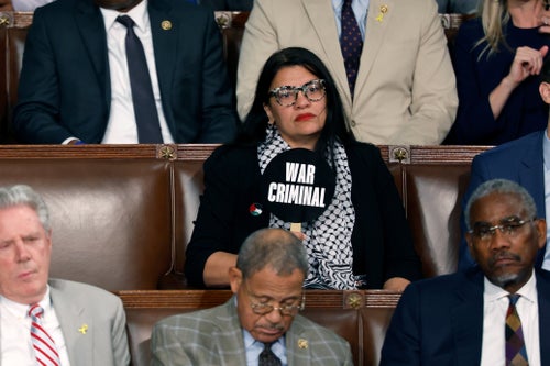 Rep. Rashida Tlaib holds a sign that reads "War Criminal" as Israeli Prime Minister Benjamin Netanyahu addresses a joint meeting of Congress on Wednesday in Washington, D.C. Netanyahu’s visit occurs as the Israel-Hamas war reaches nearly 10 months. A handful of Senate and House Democrats boycotted the remarks over Israel’s treatment of Palestine.